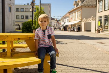 Children, family, visiting small village Flekkefjord during summer vacation in Norway