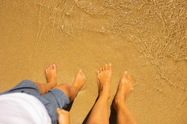 Child, cute boy, playing on the beach in the sand, enjoying summer, number sign