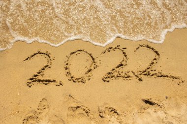 2022 sign in the sand on the beach, new year wish