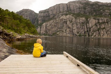Family, children, adults and dog, enjoying the beach in Forsand, Lysebotn on a cloudy day