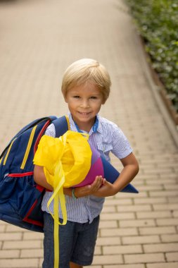 Cute blond child, boy with candy cone on first school day in Czech Republic, old German tradition that what transfer to Czzech as well