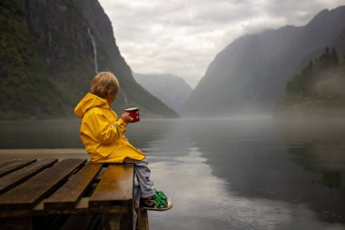 People, children enjoying the amazing views in Norway to fjords, mountains and other beautiful nature miracles