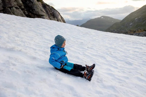 Child, boy, enjoying snow on mount Hoven, splendid view over Nordfjord from the Loen skylift