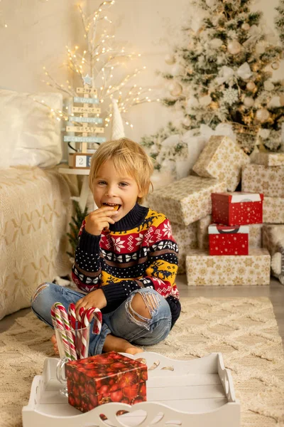 Χαριτωμένο Ξανθό Νήπιο Προνήπιο Αγόρι Τρώει Μπισκότα Και Άνοιγμα Δώρο — Φωτογραφία Αρχείου