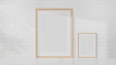 Beyaz tuğlalı duvarın üzerinde iki farklı boyutta asgari ahşap çerçeve modeli. 3d görüntüleme, 3d illüstrasyon