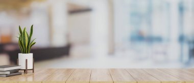 Tahta masa üstünde, kitaplarla birlikte montaj ürünleri sergisi ve kapalı ofis arka planında bulanık bitkiler için yakın çekim alanı. 3d görüntüleme, 3d illüstrasyon