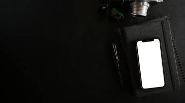 Siyah arkaplanda beyaz ekran görüntüsü olan akıllı telefonun üst görüntüsü. Üst görünüm, düz uzanma