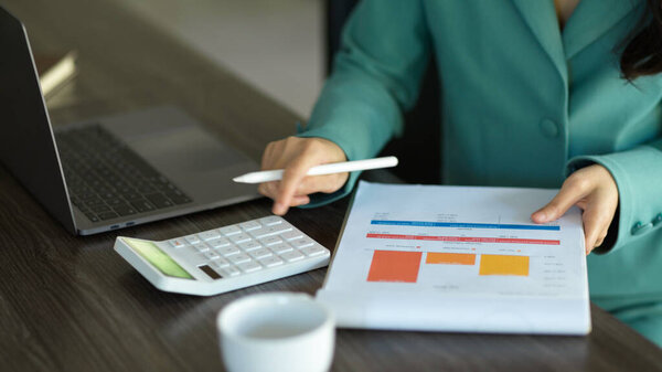 Cropped image of a female accountant calculating financial budget at her desk. financial report.