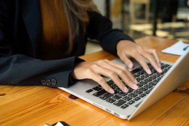 Dizüstü bilgisayar kullanan bir kadın işçinin yakın plan görüntüsü. Bilgisayarda çalışan iş kadını..