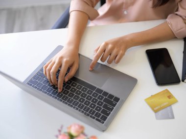 Top view of a female using laptop computer. Businesswoman working on laptop computer. Female college student working on notebook computer.