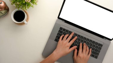 Close-up, Female's hands typing on notebook laptop keyboard on a minimal desk. laptop blank screen mockup in top view.