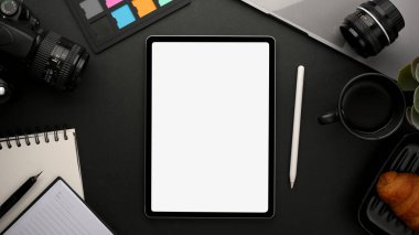 Modern creative workspace with freelance photographer's work tools, stationery and digital tablet white screen mockup. Top view