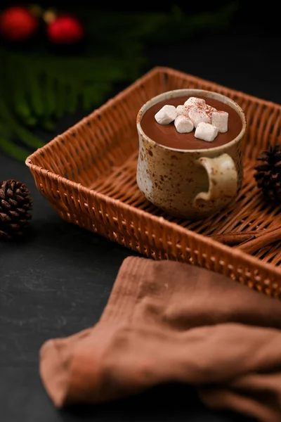 口感热的黑巧克力 有甜棉花糖和少许手工瓷杯 在黑桌旁的柳条篮里 — 图库照片