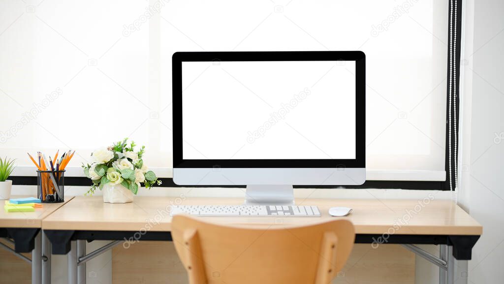 Modern office desk with computer white desktop mockup for display your graphic against bright window