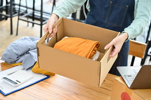 Female Fashion Clothes Shop Owner Holding Parcel Box Folded Clothes — Stock Fotó