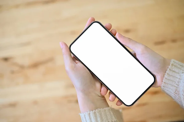 Close Image Female Hands Holding Cellphone White Screen Mockup Wooden — Zdjęcie stockowe