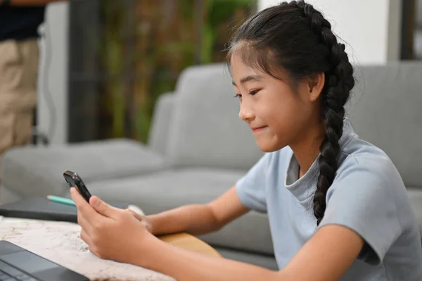 Bella Asiatica Bambina Seduta Salotto Utilizzando Cellulare Godere Guardare Alcuni — Foto Stock