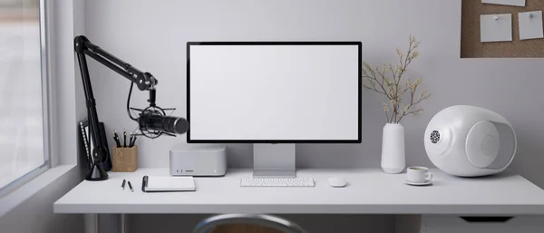 Online influencer modern workspace with computer blank screen mockup, microphone, modern speakers, accessories and decor on white table over white wall. 3d rendering, 3d illustration