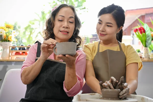 전문적 그녀의 학생을 가르치고 코치하며 작업장에서 도자기를 만들고 있습니다 도공의 — 스톡 사진