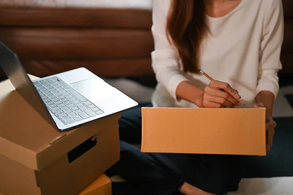 Female Small Business Owner Packing Customer Orders Writing Customer Address — Stockfoto