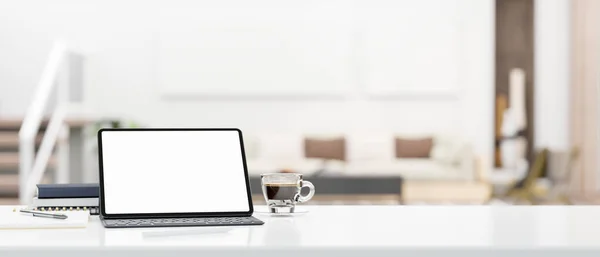 Modern workspace tabletop closeup with portable tablet touchpad white screen mockup with wireless keyboard, stuff and empty space over blurred living room in background. 3d rendering, 3d illustration