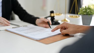 Professional female lawyer or business legal consultant in the office counselling the legal to her client. cropped image