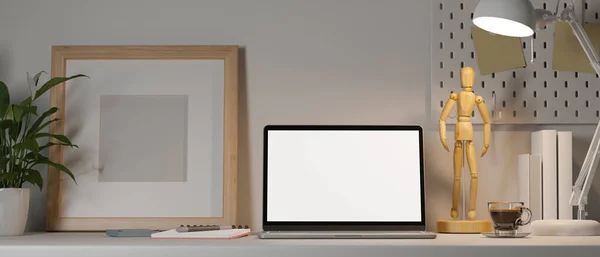 Modern workspace white tabletop with laptop white screen mockup, table lamp. wooden figure, blank frame mockup and accessories. close-up image. 3d rendering, 3d illustration