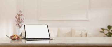 White marble tabletop with decors, digital tablet white blank screen mockup and copy space for product display over blurred minimal white living room in the background. 3d rendering, 3d illustration