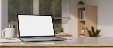 Minimal workspace tabletop with notebook laptop white screen mockup, accessories and copy space over blurred minimal home working room in the background. 3d rendering, 3d illustration