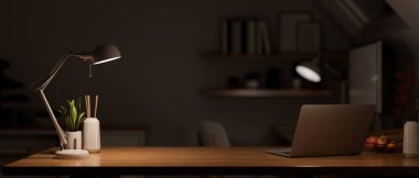 Modern dark wooden office desk at night under the warm light from table lamp with laptop computer, accessories and copy space for product display. close-up. 3d rendering, 3d illustration