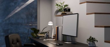 Minimal home computer desk workstation by the staircase with computer desktop mockup and accessories on black table. side view, workspace at night. 3d rendering, 3d illustration