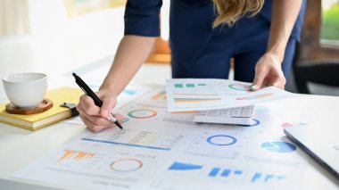 cropped shot, A professional and smart businesswoman or female financial analysts working on her financial data report, analysing the financial graph and chart.