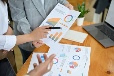 Cropped shot, A financial consultant team working together, having a meeting to analyse a financial data on the report.