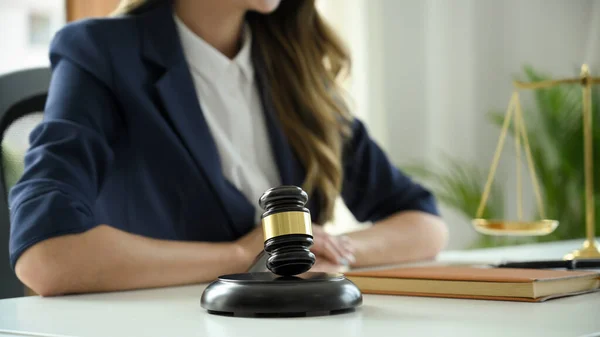 cropped and close-up image, A professional and successful female lawyer or business legal consultant sits at her office desk.