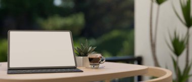 Portable digital tablet white screen mockup with wireless keyboard and coffee cup on wooden table at the balcony with forest view in background. 3d rendering, 3d illustration