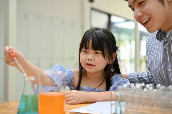 Adorable Young Asian Girl Doing Science Experiment Her Male Teacher — Stockfoto