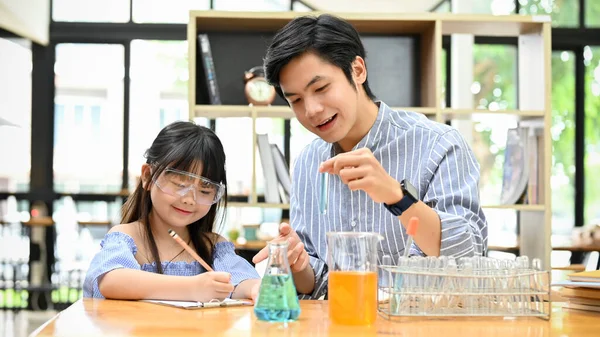 Cute Little Asian Girl Studying Science Home Her Private Tutor — Stockfoto