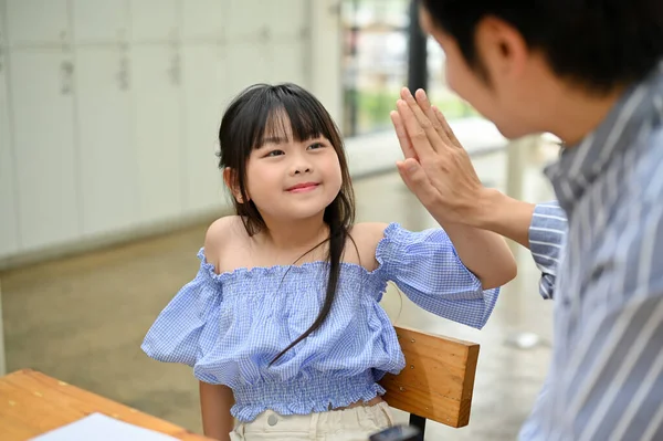 Lovely Smiling Young Asian Girl Giving High Five Her Dad — Stockfoto
