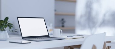 Close-up image, Modern home workspace with laptop computer white screen mockup, coffee cup, spiral notepad and stuff on white table. 3d rendering, 3d illustration