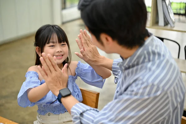 Happy Smiling Little Asian Girl Giving High Five Her Dad — Stockfoto