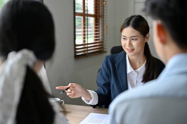 Attractive and professional Asian female boss or businesswoman is interviewing two candidates in her office. Job employment to recruitment concept