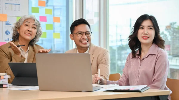 Cheerful and happy Asian businesspeople or team interviewers in the meeting, concentrating on listening to work candidates answer a question. Job recruitment concept