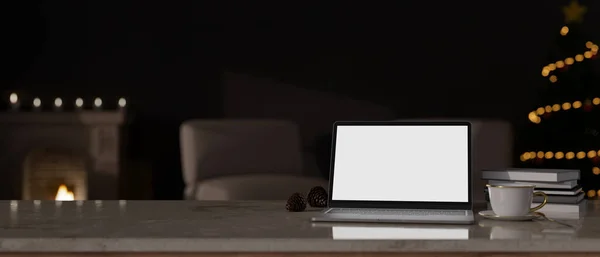 Cozy home workspace at night with laptop white screen mockup, coffee cup and copy space on tabletop over blurred dark living room in background. 3d render, 3d illustration