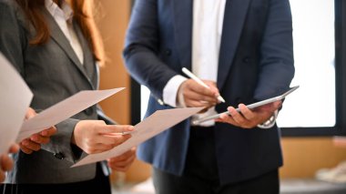Resmi takım elbiseli profesyonel bir iş adamı patronlarıyla toplantıda, gazetede bir toplantı bilgisi okuyorlar. kırpılmış resim