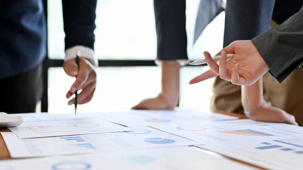 A group of professional businesspeople or financial consultants are having a financial meeting in the conference room. close-up and focus hands image