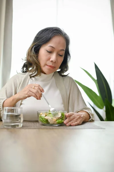 肖像画 健康的なアジアの女性は彼女のダイニングルームで健康的な朝食を持っている 緑の野菜と鶏の胸肉とサラダボウルを食べる — ストック写真