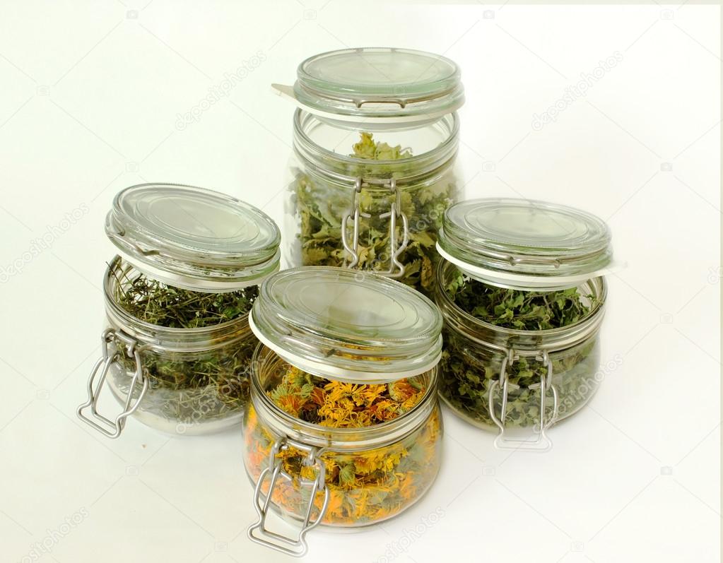 Herbs in Glass Botltles Isolated on White Background