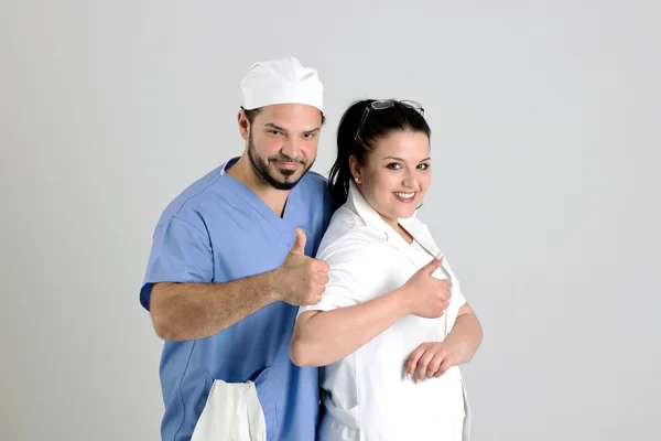 Equipo Clínico de Médico y Cirujano Mujer está mostrando Signo Nr.1 —  Fotos de Stock