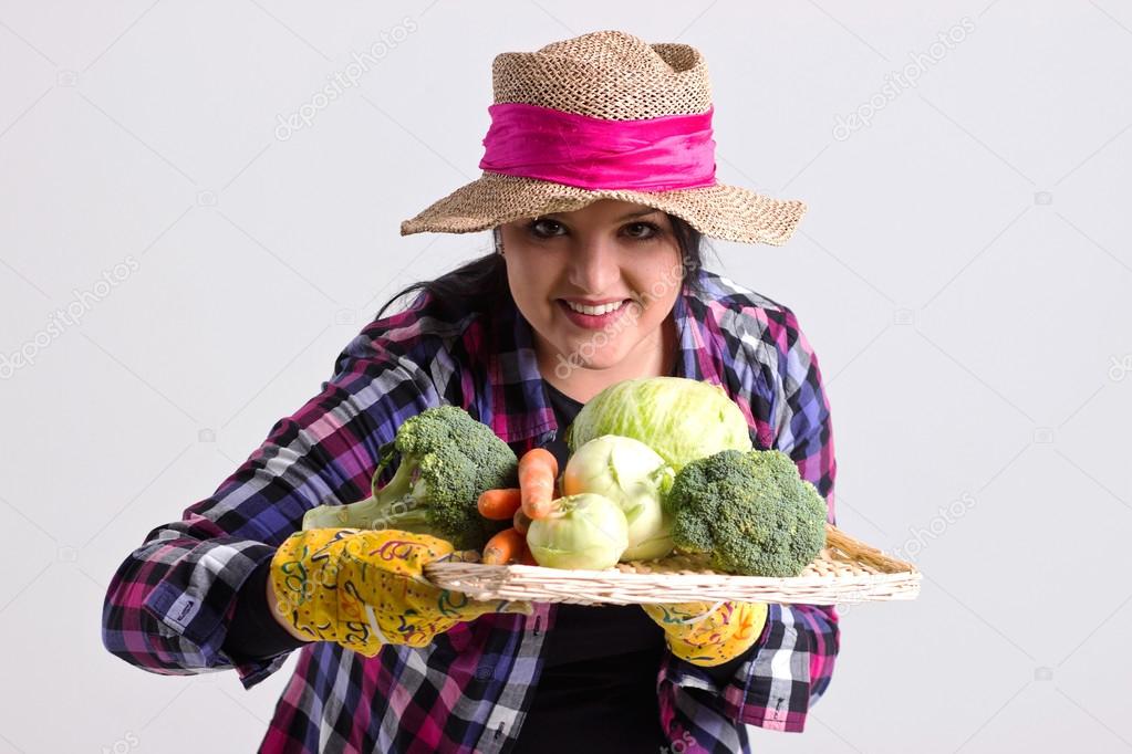 Garden Woman in Leghorn Holds a Tray Full of Vegetables