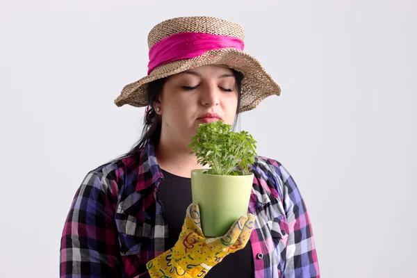 Woman Gardener in Leghorn is Smelling a Herb — Stock Photo, Image